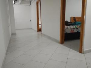 a hallway with a white tiled floor in a room at WalApar in San Rafael +4 photos