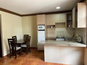 a kitchen with a counter and a table with chairs at Casa Danna in Sucre