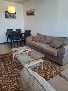 a living room with a couch and a table at Agradable Dpto Calama Centro in Calama
