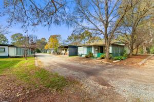 an empty road in front of some buildings at Howlong Caravan Park in Howlong