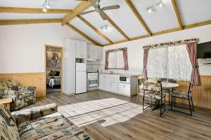 a kitchen and living room with a table and chairs at Howlong Caravan Park in Howlong