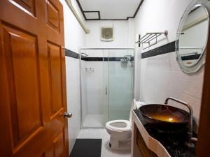 a bathroom with a sink and a toilet and a shower at บ้านกูรูรีสอร์ท in Ban Thung Satong +21 photos