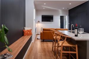 a kitchen and living room with a bar and a couch at Sixty - House 1 in Currie