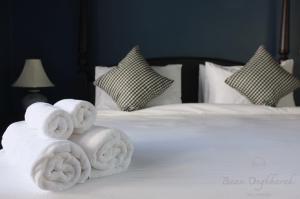 a white bed with towels on top of it at Baan Ongkharak bed & breakfast in Bangkok