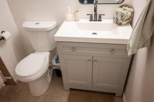 a bathroom with a toilet and a sink at Spacious 2-Bedroom Basement Suite in Whitehorn, Close to Calgary Airport, Hospital, & Train in Calgary +24 photos