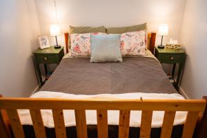 a bedroom with a large bed with two night stands at Spacious 2-Bedroom Basement Suite in Whitehorn, Close to Calgary Airport, Hospital, & Train in Calgary