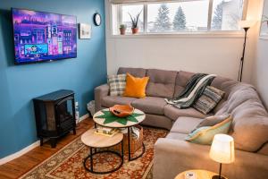 a living room with a couch and a fireplace at Spacious 2-Bedroom Basement Suite in Whitehorn, Close to Calgary Airport, Hospital, & Train in Calgary