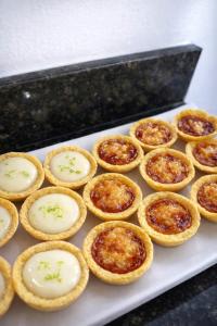 a bunch of pies on a white plate at Pousada Doce Mar in Maragogi