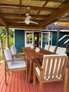 a wooden table and chairs on a deck at Sea Turtle Lodge and Villas in Rarotonga