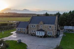 an aerial view of a large stone house at Waterside Equestrian Lodge in Durham