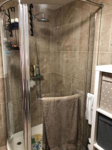a bathroom with a shower with a glass door at Waterside Equestrian Lodge in Durham +46 photos