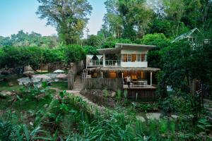 a house in the middle of a forest at Nuearnaam Lychee House Chiang Mai in Ban Pa Miang