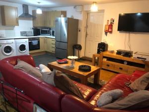 a living room with a couch and a table at Waterside annexx in Durham