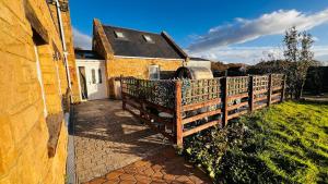 a wooden fence in front of a house at Waterside annexx in Durham