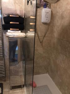 a shower in a bathroom with a phone on the wall at Waterside annexx in Durham +7 photos