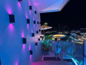 a woman standing next to a wall with purple lights at Wyndham studio 2205 in Surin Beach +57 photos