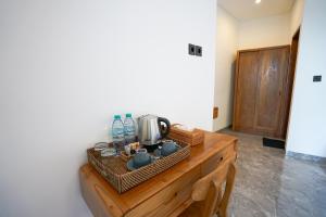 a room with a wooden table with a coffee maker on it at Sandat Garden House in Ubud