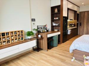 a bedroom with a bed and a desk with a dispensary at Măng Homestay in Xuân Quan
