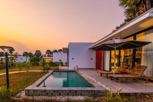 a house with a swimming pool and a patio at Good Time Relax Resort in Kampot +171 photos
