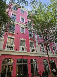 a pink building on the side of a street at Sunday Boutique Hotel in Phú Quốc
