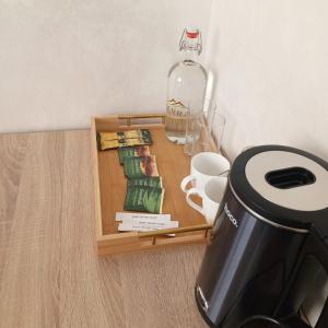 a small table with a bottle of water and a coffee maker at Гостиница TERRA in Almaty