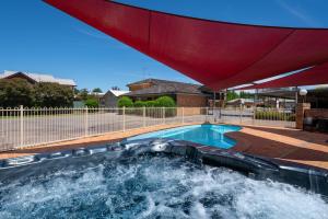 a swimming pool with a water slide at Ben Chifley Motor Inn in Bathurst