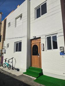 a building with two bikes parked in front of it at 목포 달달마실 게스트하우스 in Mokpo