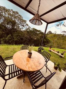 a wooden table and chairs on a patio at Kèbi Container Home near Blue Falls in Colonia