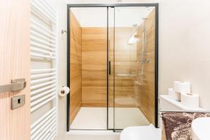 a shower in a bathroom with a glass door at Formanka Hanušovice in Hanušovice +128 photos