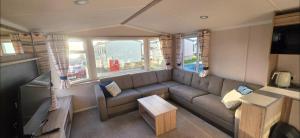 a living room with a couch and a tv at Mason's Morecambe Memories in Heysham