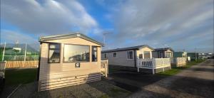 a couple of tiny houses in a parking lot at Mason's Morecambe Memories in Heysham