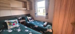 a small bedroom with a bed and a window at Mason's Morecambe Memories in Heysham +32 photos
