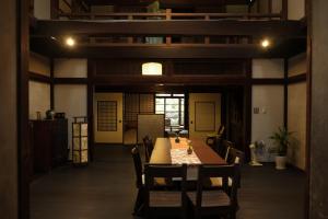 a dining room with a table and chairs at Etchu Yatsuo Base OYATSU in Toyama