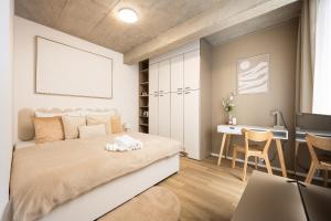 a bedroom with a large bed and a desk at Internesto Brno HUB in Brno +14 photos