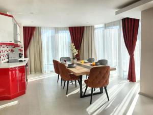 a dining room with a table and chairs in a kitchen at Alfa Apart Hotel in Antalya