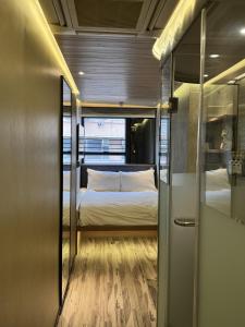a small bedroom with a bed in a room at M Plus Hotel in Hong Kong
