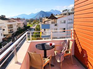 a table and chairs on a balcony with a view at Alfa Apart Hotel in Antalya