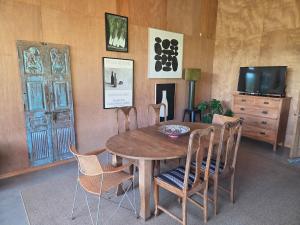 a dining room with a wooden table and chairs at Barn Apartment in Earnscleugh