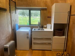 a small kitchen with a sink and a refrigerator at Barn Apartment in Earnscleugh