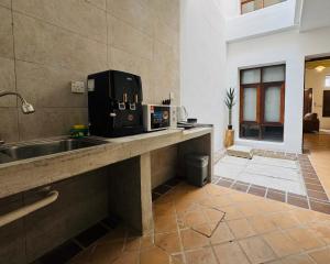 a microwave sitting on a counter in a room at Courtyard by Heritage Row in George Town +162 photos