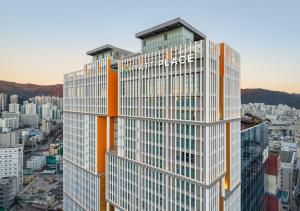 a tall building with a hilton sign on it at Hyatt Place Busan Yeonsan in Busan