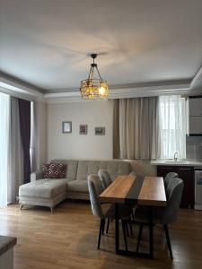 a living room with a couch and a table at Alfa Apart Hotel in Antalya