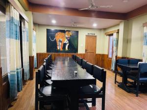 a conference room with a tiger painting on the wall at Hotel Royal Swiss in Sauraha