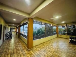 an empty room with a balcony with a view at Hotel Royal Swiss in Sauraha