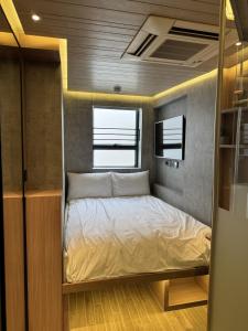 a small bedroom with a bed in the middle at M Plus Hotel in Hong Kong