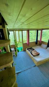 a bedroom with a bed in the middle of a room at Jibhi Pine Nature Tree house in Jibhi