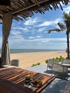 a table with a plate of food on the beach at Golden Terra Villa in Phan Thiet