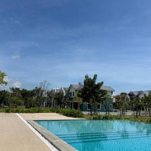 a swimming pool in front of some houses at Golden Terra Villa in Phan Thiet