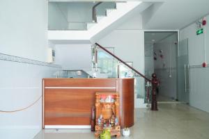 a kitchen with a counter with a sink and a staircase at Tâm An Hotel in Nhơn Trạch