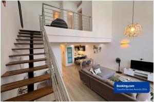 a living room with a couch and a staircase at SG5 l Le Turquoise - third line building - Beachfront Residence in Cap Malheureux